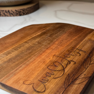 Personalised chopping board with engraved couple’s names and heart design